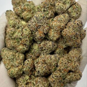 Close-up of Glitter Bomb THCa Flower buds showcasing dense trichomes